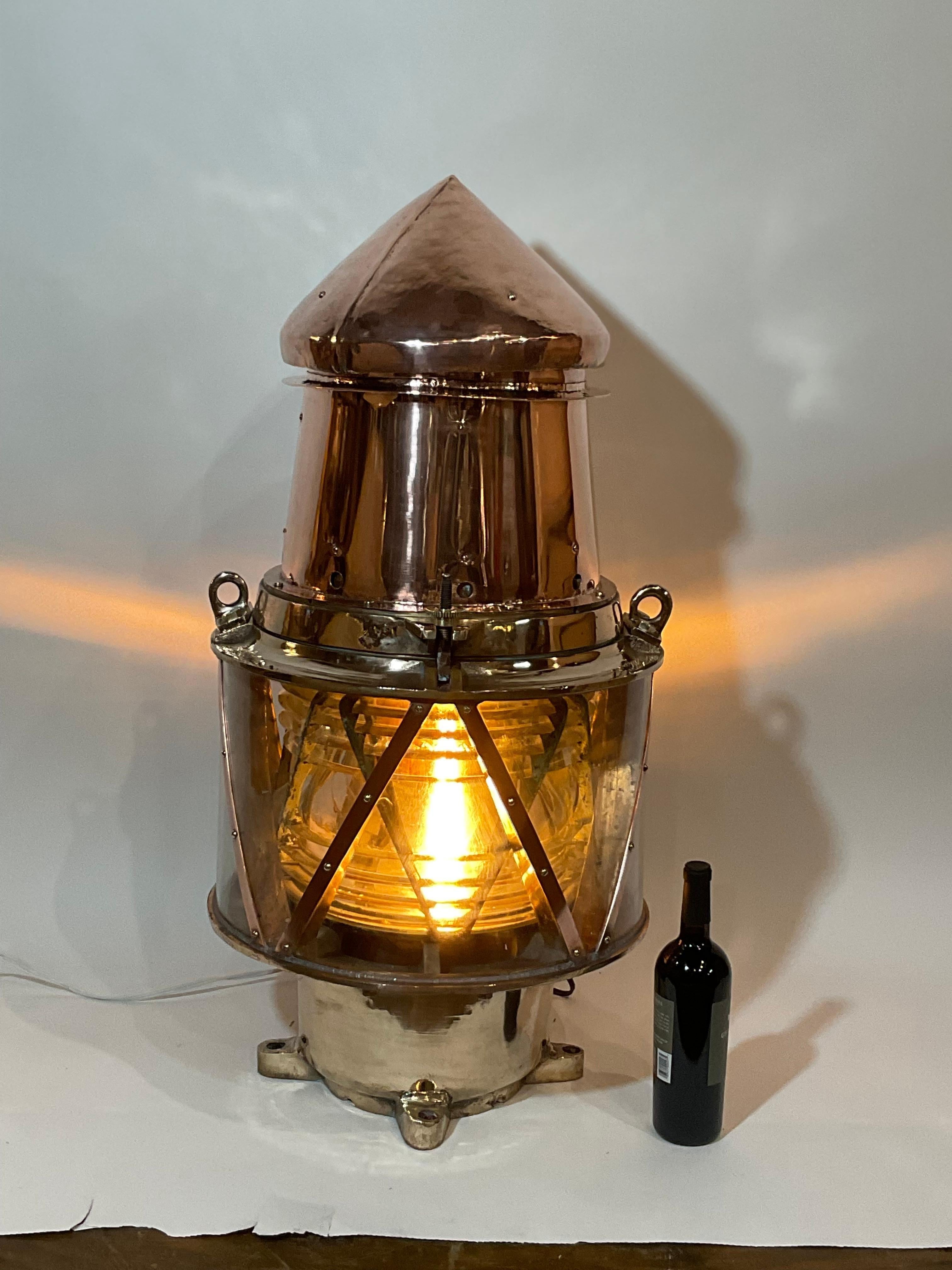 Copper buoy light with bronze frame Fresnel lens. Hinged top with brass hinges and bezel. Built to the highest quality to withstand decades at sea. Professionally polished. Fitted with AC sockets.

Weight: 50 lbs.
Overall Dimensions:
Made: