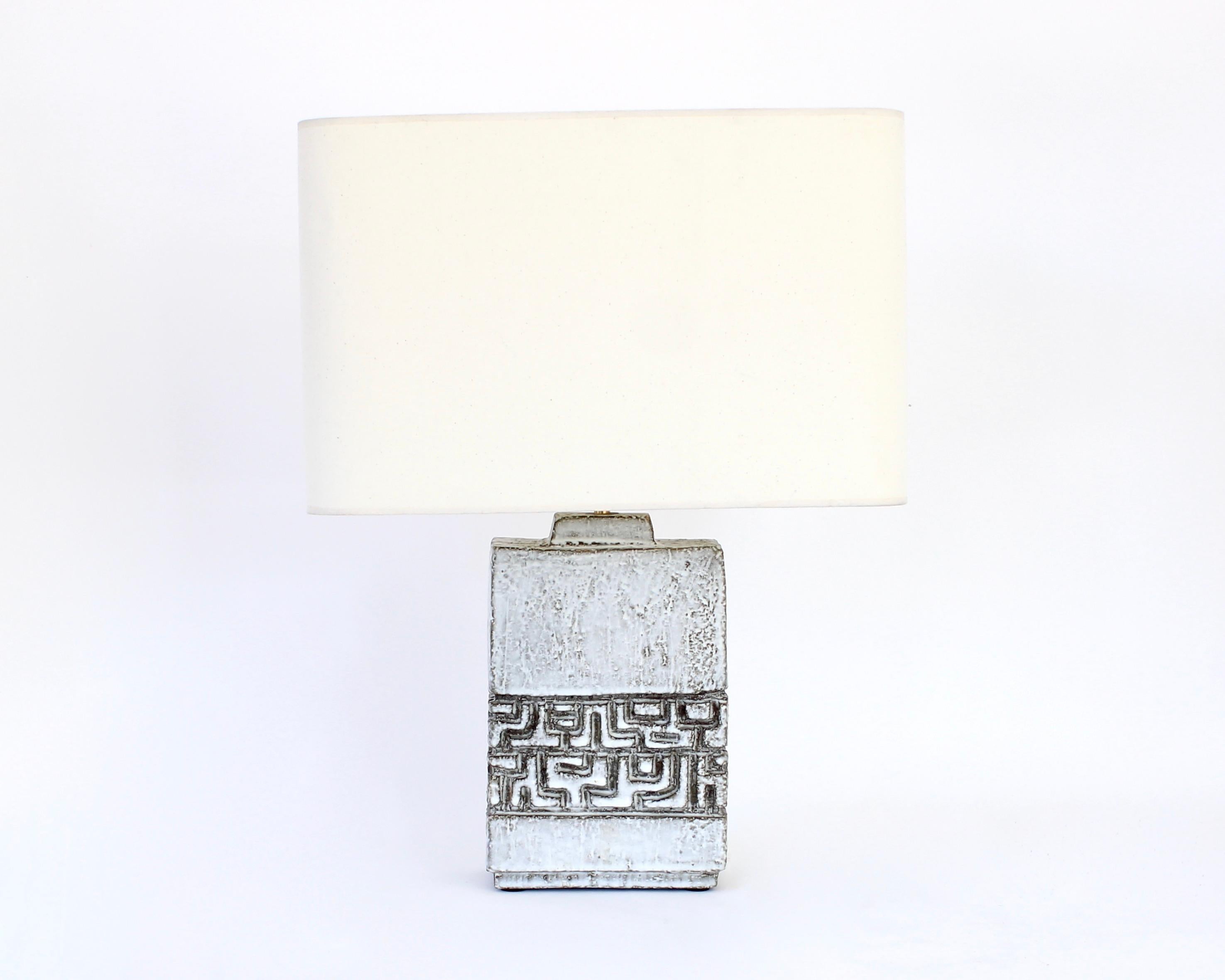Marius Bessone ceramic table lamp with shade. Bessone had his ceramic studio and atelier in Vallauris France.
This lamp has iconic Bessone incised markings and iconic off white cream and brown gray glaze with a lot of texture in the surface of the