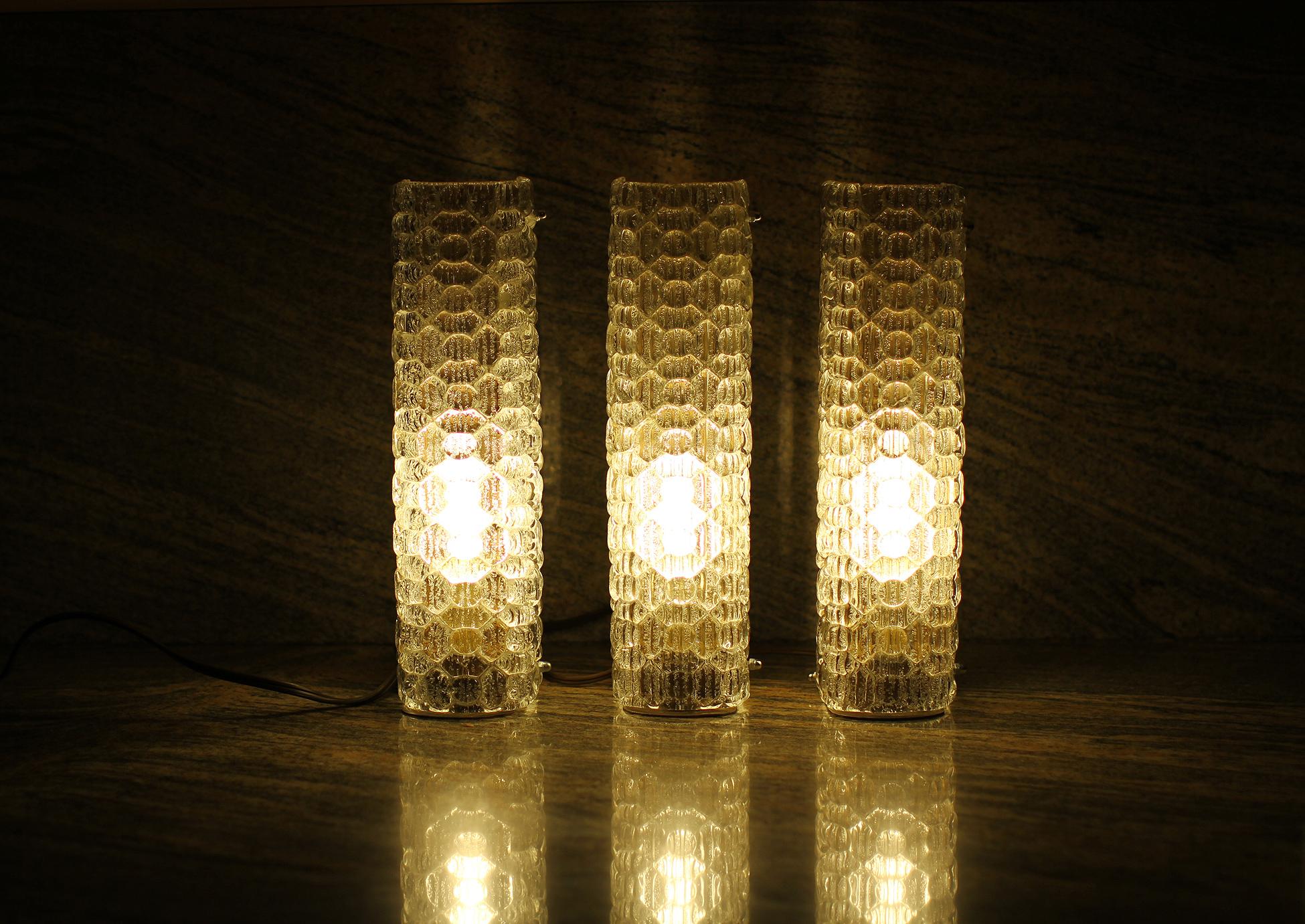 Marius Ernest Sabino and Jacques Adnet ( attributed to )
Exceptional set of three sconces. The base is in brass and the shades are shaped and textured glass with a floral motif. The bases are in original condition. Both have been rewired for U.S.