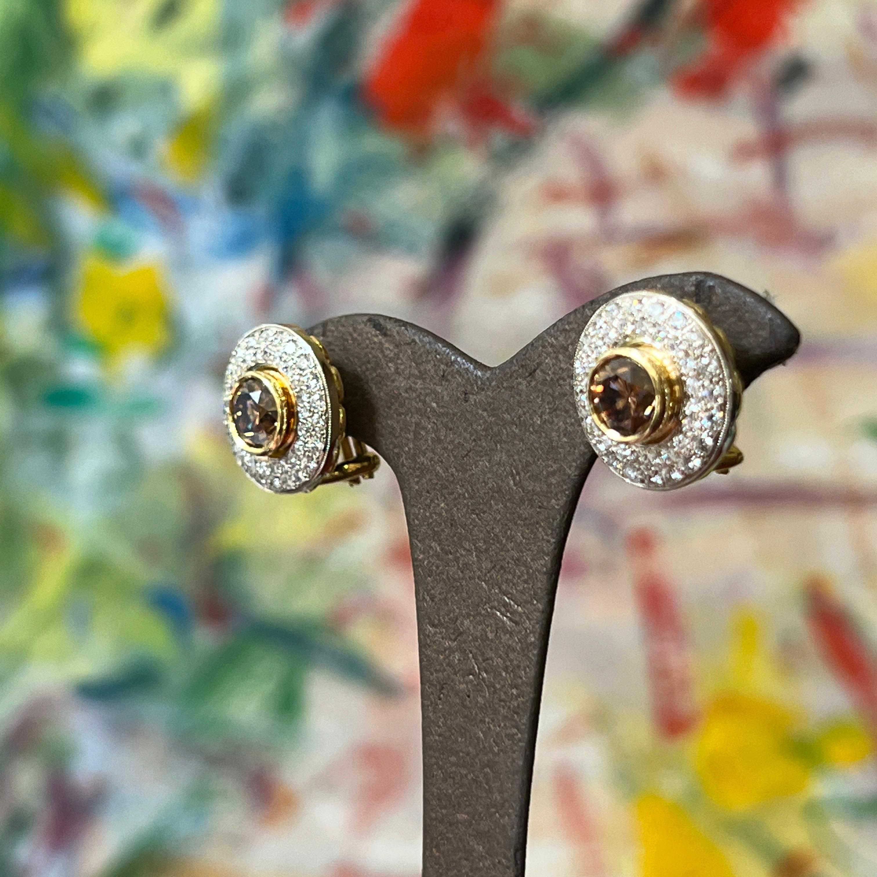 Designed and handmade by Mark Areias Jewelers. Chocolate cognac round brilliant cut main diamonds are bezel set in 18K yellow gold. Surrounded by pave set premium white round brilliant cut diamonds in white gold. The earrings are a round shape