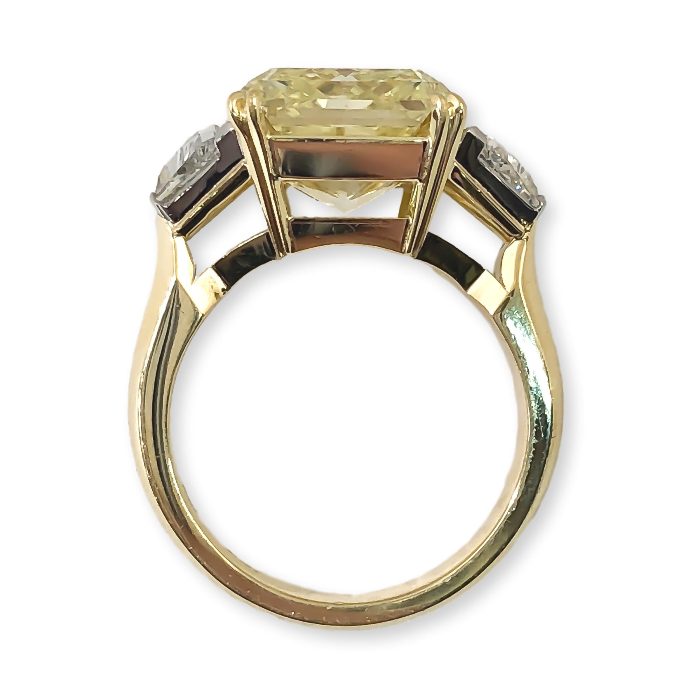 This ring is designed and hand fabricated by Mark Areias Jewelers in Platinum and 18K yellow gold. The center diamond is an fancy cushion shape rare fancy yellow color set in yellow gold double prongs. The center diamond is flanked by two white