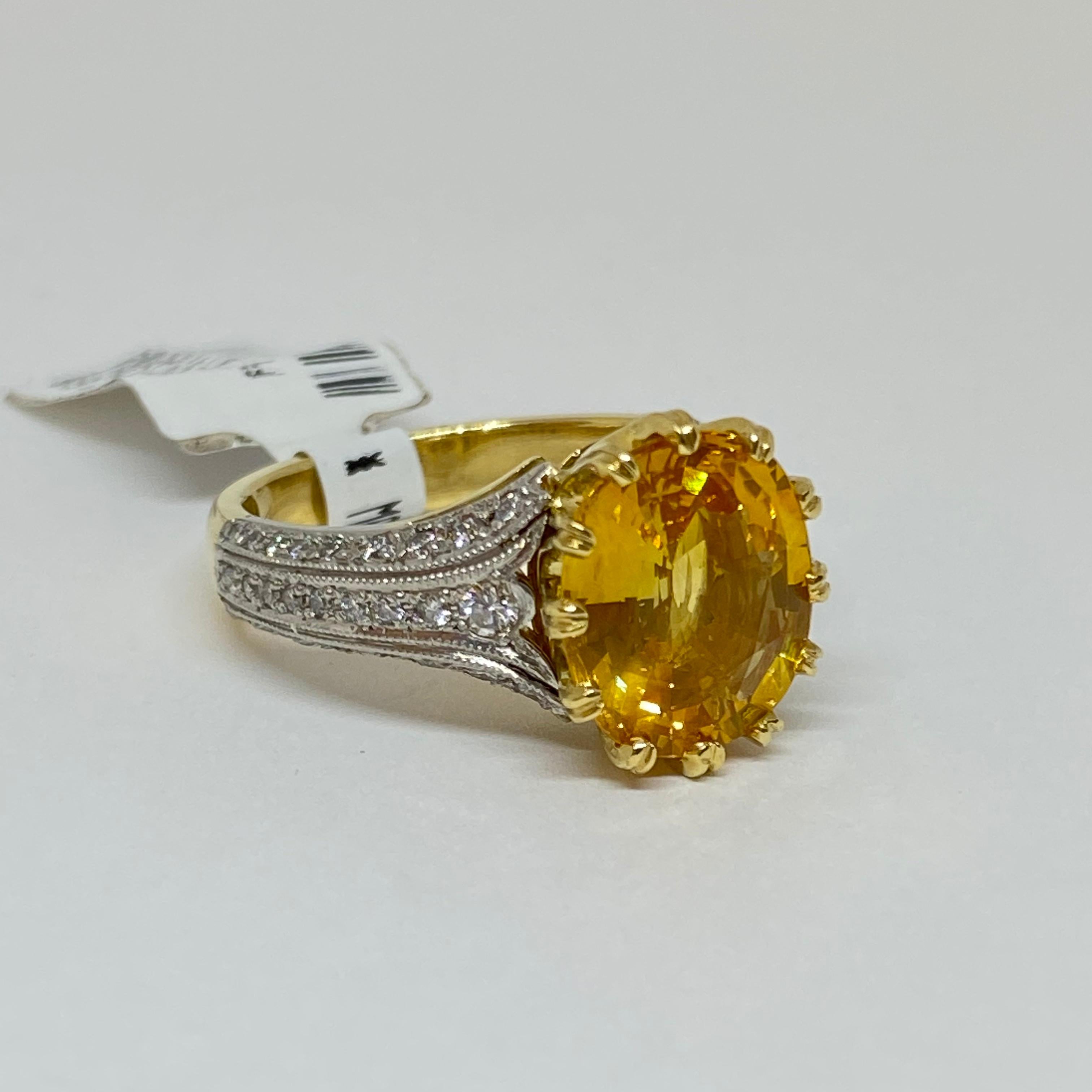 The ring is designed and handmade by Mark Areias Jewelers in 18 karat yellow gold and platinum. The ring contains a natural oval yellow sapphire and round brilliant cut diamonds. The beautiful natural sapphire is set in our signature multi prong