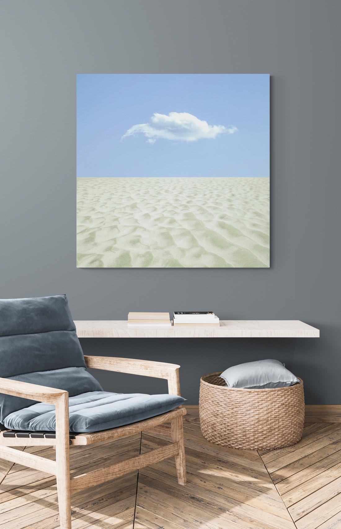 This compelling contemporary photograph of a seaside landscape is by Mark Bartkiw. A single white cloud in a pale blue sky appears to float above an ocean of white sand. The image is somewhat ‘otherworldly’ as Bartkiw is known for his imaginative