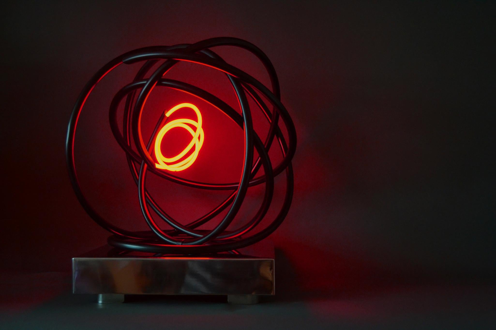 Small Red Neon Orb was first shown at London Art Fair 2018. The sculpture is mounted onto a mirror polished stainless steel plinth, which is perfect for displaying the piece on a table. Small Red Neon Orb also has a floor standing metal plinth, the