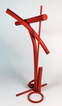 This vertical, free standing welded red sculpture is titled Leap of Faith #3. 
