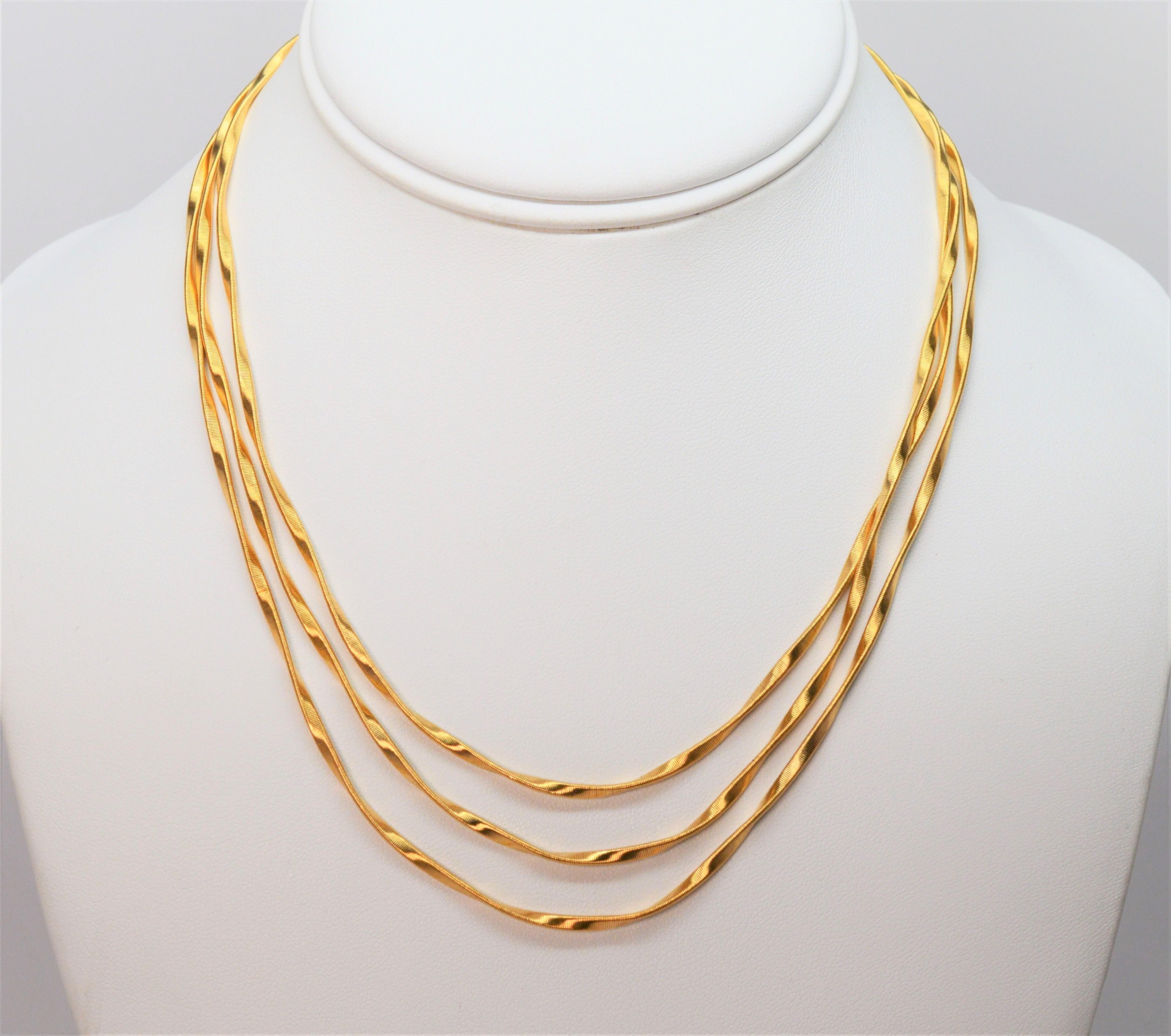 The mastery of artisanal techniques shine in the hand hammered and hand twisted strands of eighteen karat 18K yellow gold that create this contemporary multi strand collar necklace by Italian designer Marco Bicego. From the Marrakech Collection,