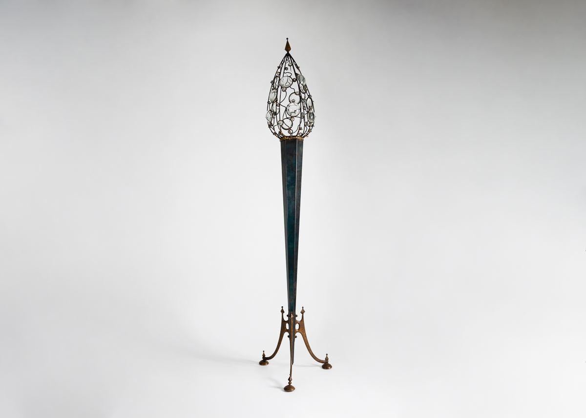 One of a kind pieces crafted by the artist himself. A pair of floor lamps of bronze, steel, and glass, exceptional for their monumental size, and their juxtaposition of jarring elements with equally beautiful ones. Each lamp takes the form of a