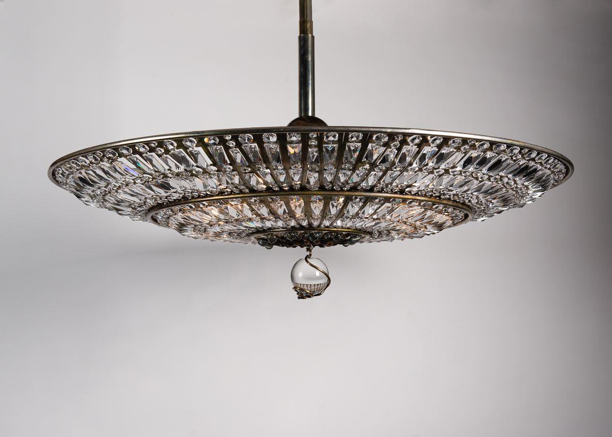 Libertine is a grand, crystal chandelier, arranged on a brooding, brass plated frame of steel. Like much of Brazier-Jones' work, the piece focuses on repeating, naturally imperfect, patterns, and elicits dark feelings as readily as awe at its size