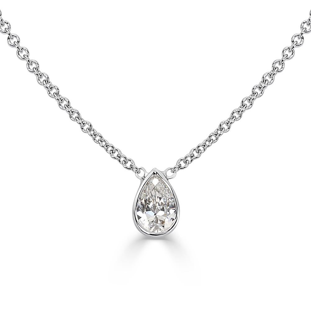 Handcrafted in 18k white gold, this lovely diamond pendant showcases an exquisite 0.20ct pear shaped center diamond graded at F-VS2. Absolutely perfect for any occasions!
