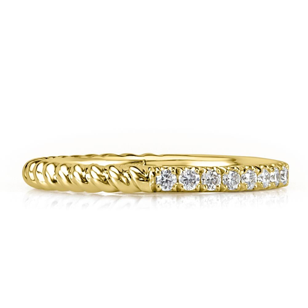 Handcrafted in 18k yellow gold, this feminine diamond wedding band features an exquisite design of half circle diamonds and half circle rope texture. The round brilliant cut diamonds total 0.30ct in weight and are graded at E-F, VS1-VS2.