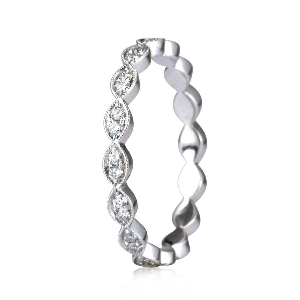 This scalloped pavé diamond eternity band is set with 0.35ct of round brilliant cut diamonds handset in a delicate 18k white gold, milgrain setting. The diamonds are perfectly matched and graded at E-F, VS1-VS2. All eternity bands are shown in a