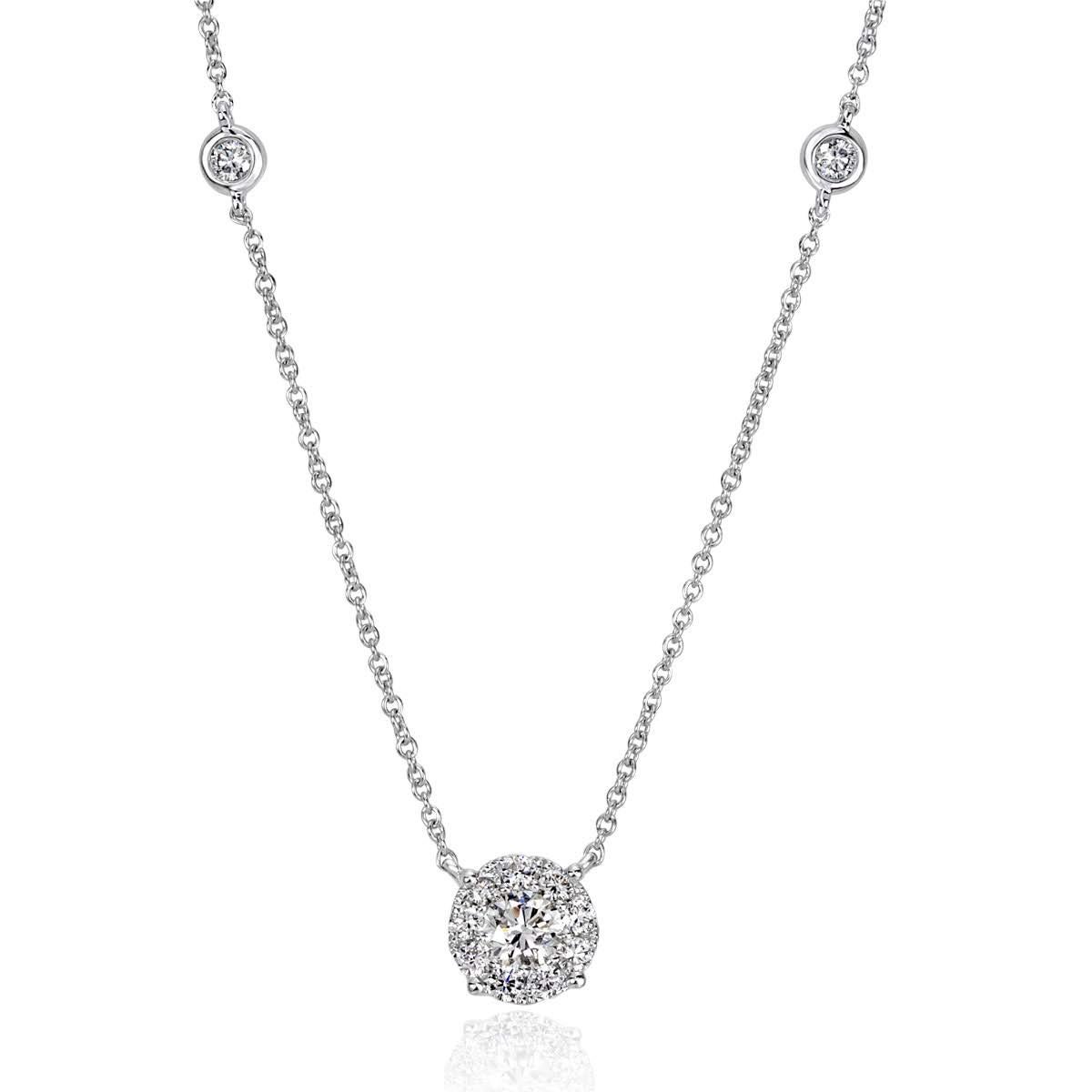 Custom created in 14k white gold, this lovely diamond pendant features 0.41ct of round brilliant cut diamonds. A larger round diamond is set at the center and surrounded by a shimmering halo of smaller diamonds. The diamonds are graded at E-F,