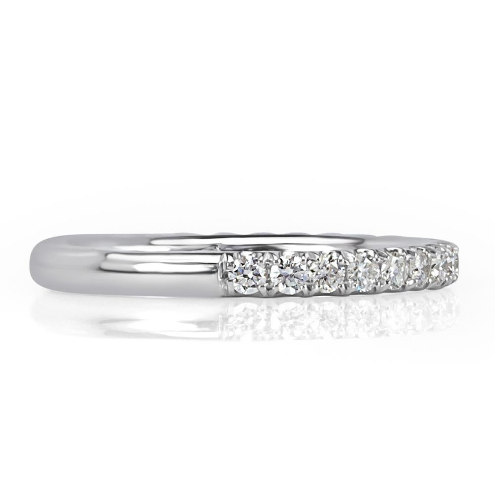 This beautiful diamond wedding band features 0.45ct of round brilliant cut diamonds micro pavé set past half way down in this high polish 18k white gold setting. The diamonds are graded at E-F, VS1-VS2.