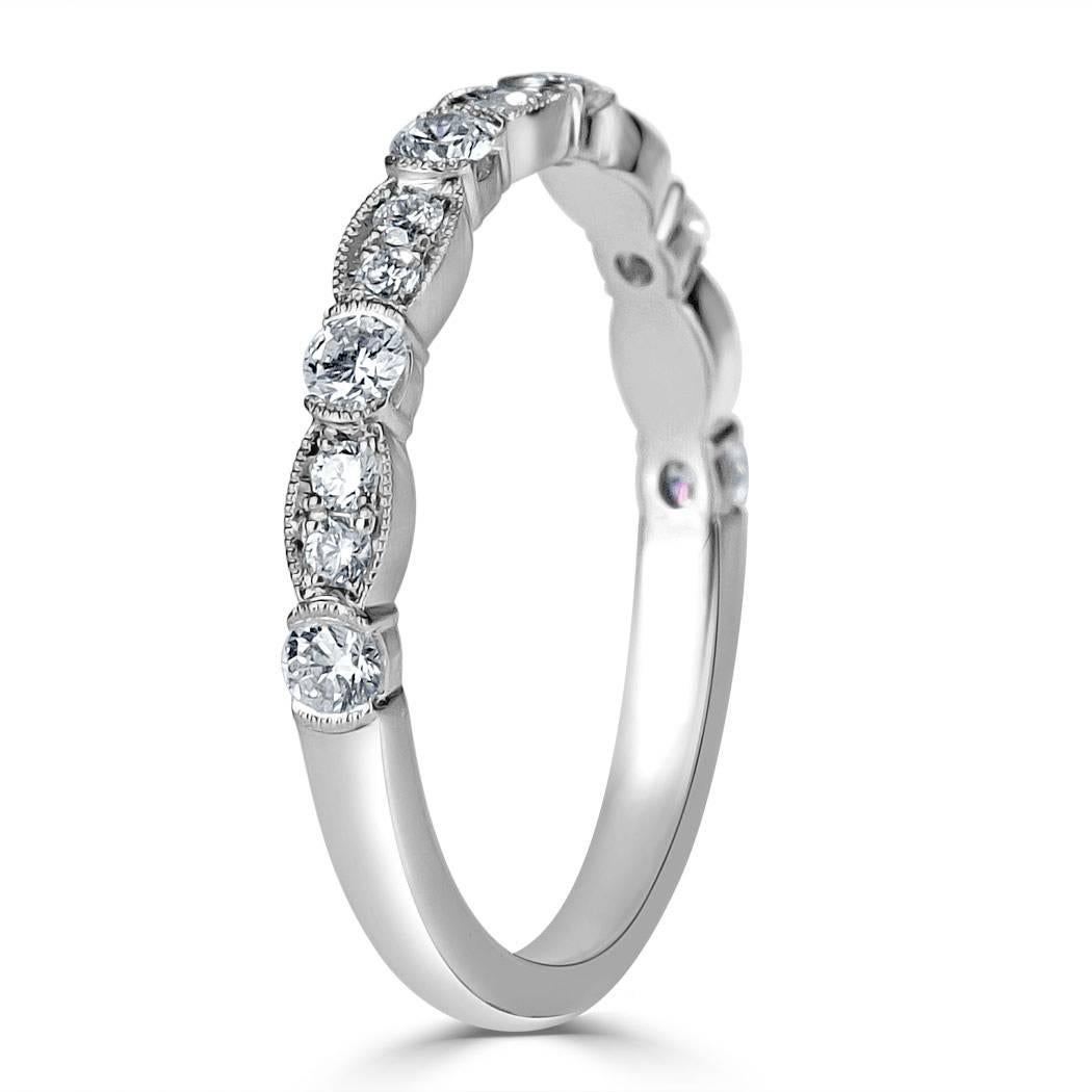 This lovely and feminine diamond wedding band is set with 0.45ct of round brilliant cut diamonds. All of the diamonds are graded at E-F, VS1-VS2 and hand set in this 18k white gold setting featuring milgrain detail throughout.