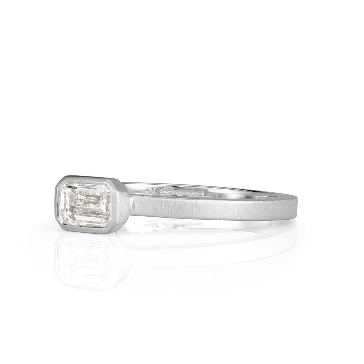 This ravishing diamond band showcases a 0.45ct emerald cut center diamond bezel set in an 18k white gold, satin finish setting style. It is graded at F in color, VS1 in clarity.
