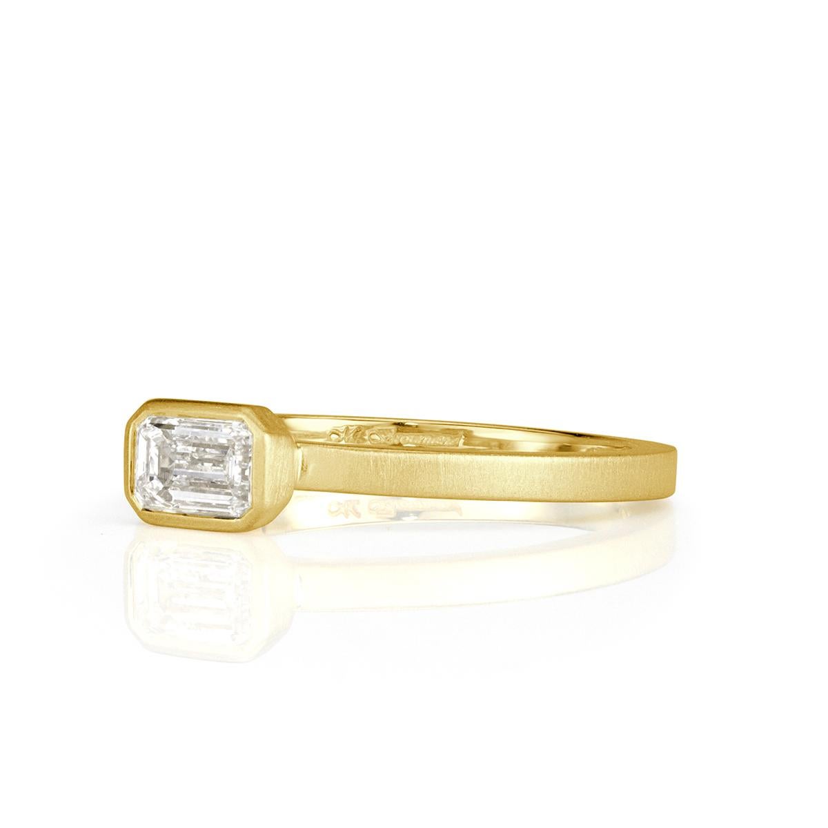 This chic diamond band showcases an exquisite 0.45ct emerald cut center diamond graded at F in color, VS1 in clarity. It is bezel set in a satin finish, 18k yellow gold setting style. Absolutely perfect for everyday wear!
