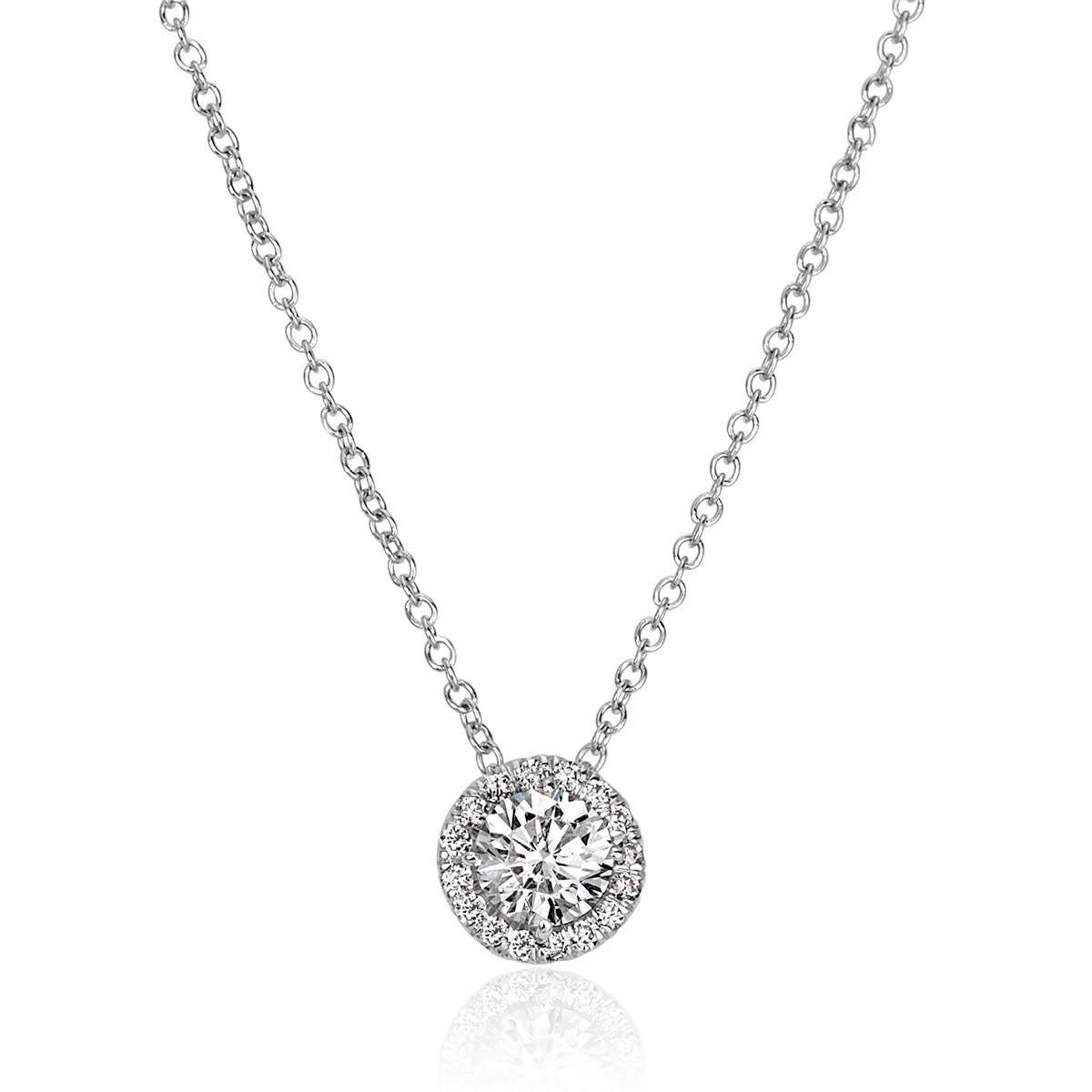 This exquisite diamond pendant features 0.47ct of round brilliant cut diamonds, with a larger round brilliant cut diamond set at the center surrounded by a shimmering halo of smaller round diamonds. The diamonds are graded at E-F in color, VS2-SI1