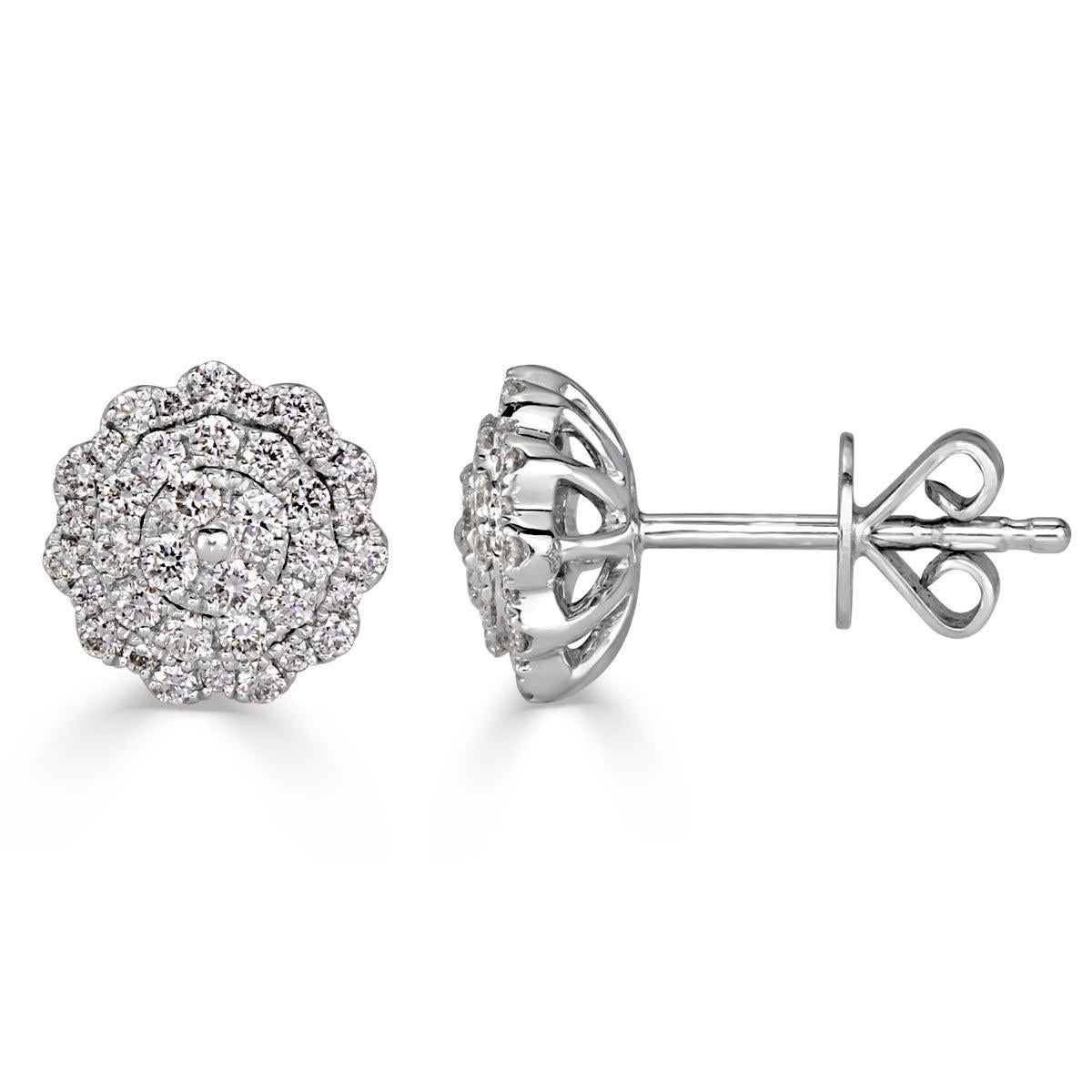 Handcrafted in 14k white gold, this feminine pair of diamond stud earrings features 0.47ct of round brilliant cut diamonds micro pavé set in a mesmerizing design. The diamonds are graded at E-F, VS1-VS2.