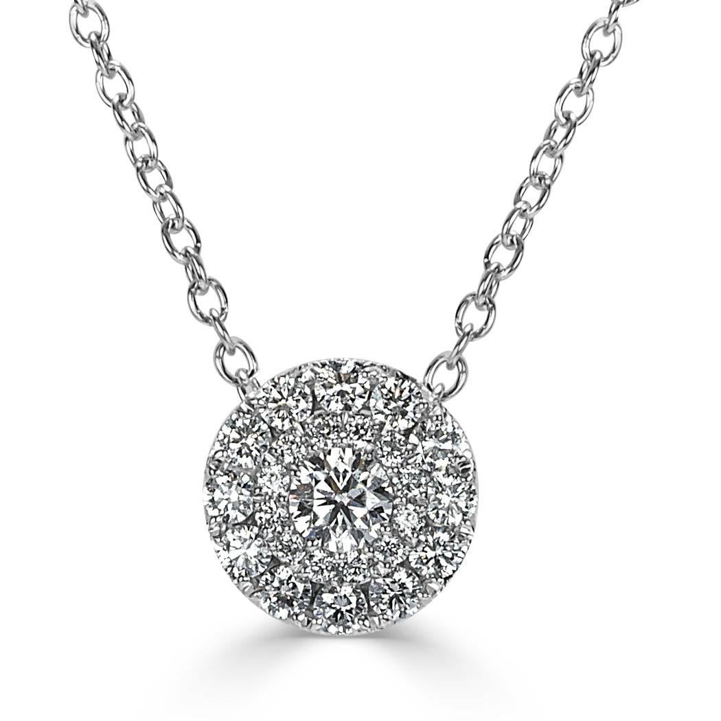 This lovely double halo diamond pendant is set with 0.50ct of round brilliant cut diamonds graded at E-F, VS1-VS2. They are impeccably matched and micro pavé set in 14k white gold.