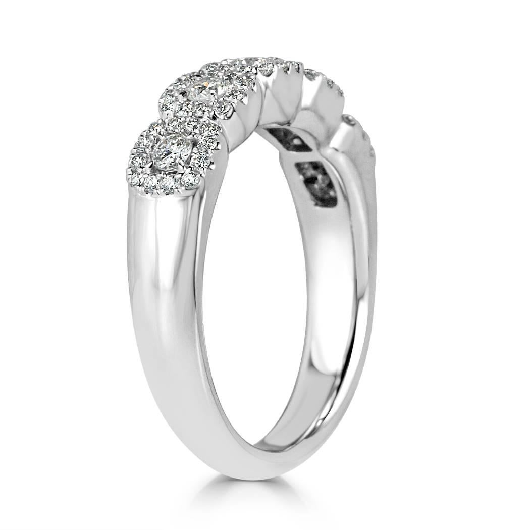 Handcrafted in 14k white gold, this exquisite diamond ring is set with 0.50ct of round brilliant cut diamonds graded at E-F in color, VS1-VS2 in clarity. The piece features larger round diamonds surrounded by individual halos of smaller round