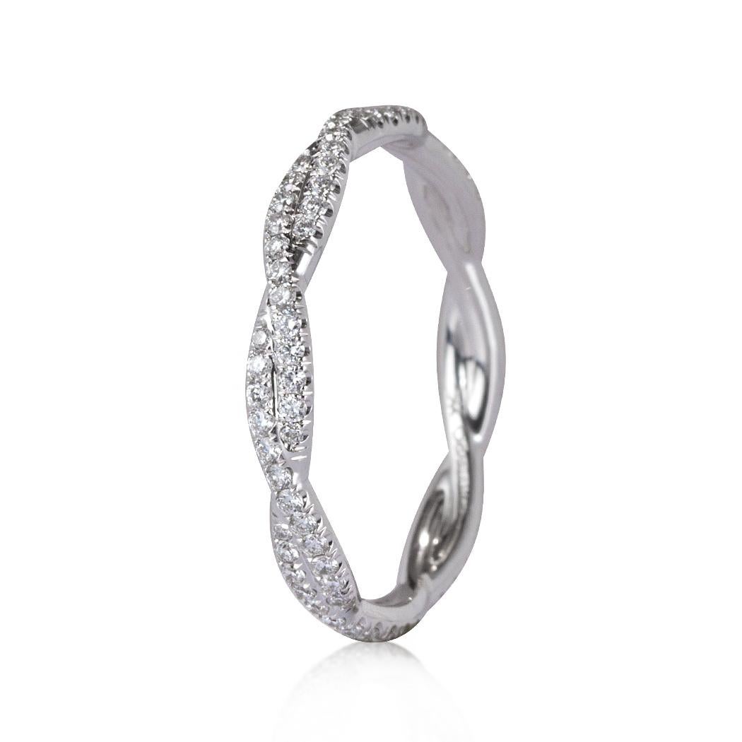 This exquisite diamond wedding band showcases a twisted design studded with 0.35ct of round brilliant cut diamonds. The diamonds are graded at E-F in color, VS1-VS2 in clarity. It is perfect to wear on its own or to pair with your engagement ring!
