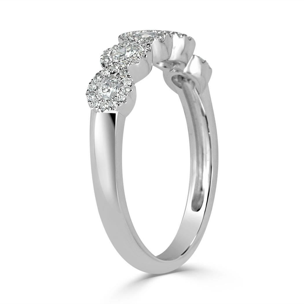 This beautiful diamond ring showcases 0.55ct of round brilliant cut diamonds graded at E-F, VS1-VS2. It showcases five larger round diamonds each encased in a halo of glittering diamonds. They are all perfectly matched and hand set in 14k white gold.