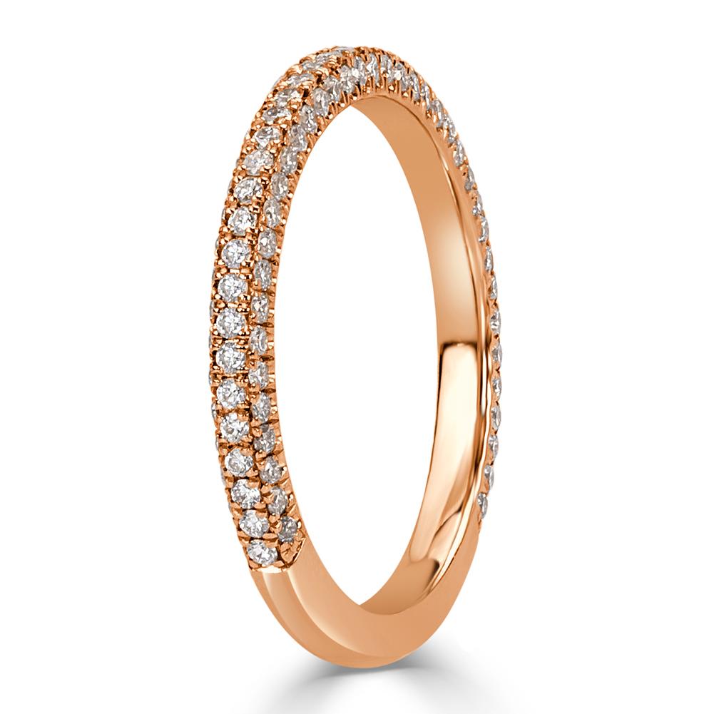 This dazzling diamond wedding band features three rows of round brilliant cut diamonds micro pavé set in 18k rose gold. The diamonds total 0.60ct in weight and are graded at E-F in color, VS1-VS2 in clarity.