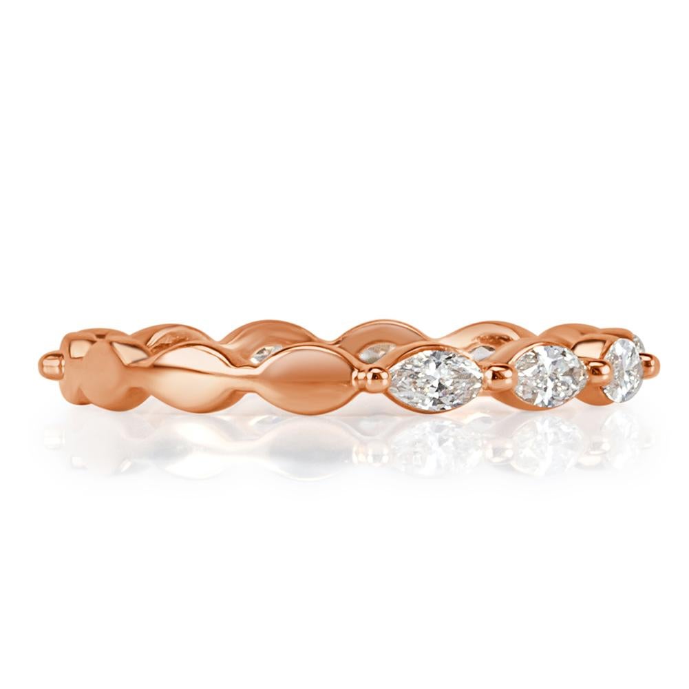 This feminine and versatile diamond wedding band features 0.65ct of marquise cut diamonds set in 18k rose gold. The diamonds are each hand selected and graded at E-F, VS1-VS2.