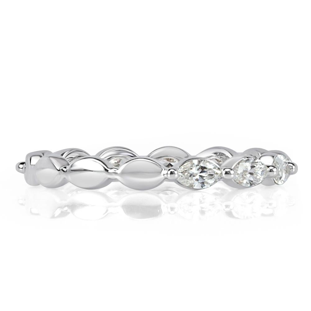 This feminine diamond wedding band showcases 0.65ct of marquise cut diamonds hand set in high polish platinum. The diamonds are graded at E-F, VS1-VS2.