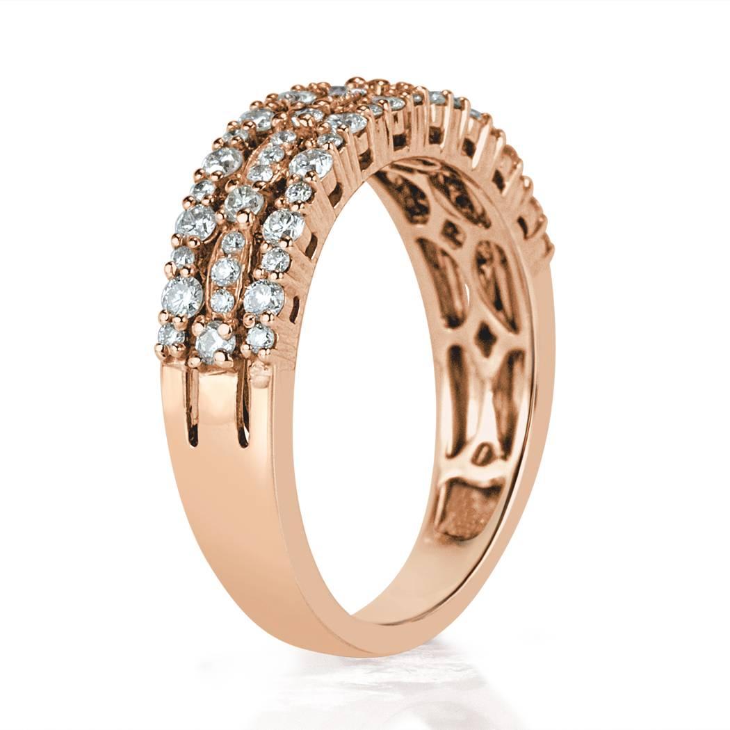 Created in 14k rose gold, this ravishing diamond ring is set with 0.65ct of round brilliant cut diamonds graded at E-F in color, VS1-VS2 in clarity. It features three rows of large and small alternating round diamonds set in a lovely shared prong
