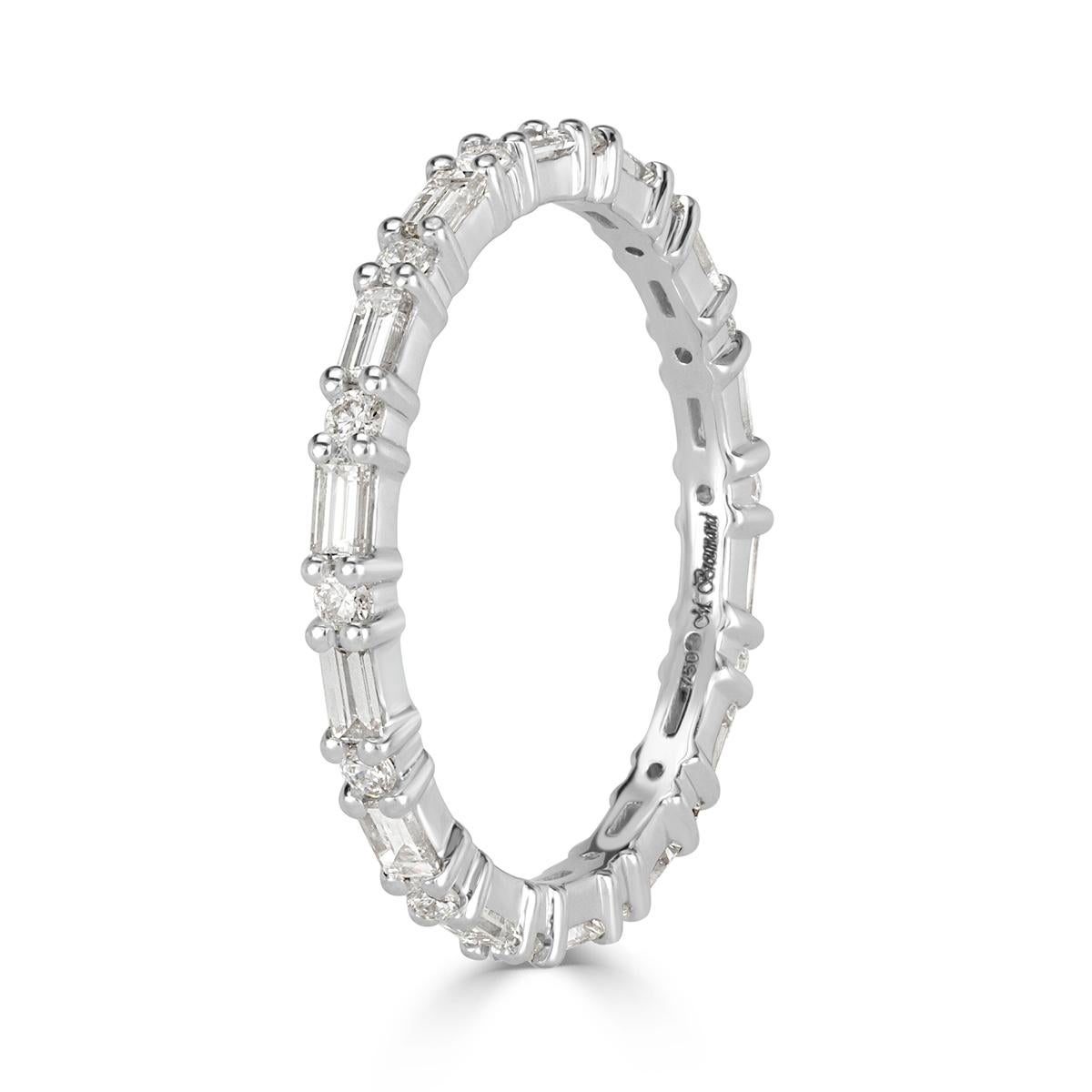 This ravishing diamond eternity band showcases 0.77ct of baguette and round brilliant cut diamonds graded at E-F in color, VS1-VS2 in clarity. The diamonds are set in a custom, 18k white gold setting. All eternity bands are shown in a size 6.5. We