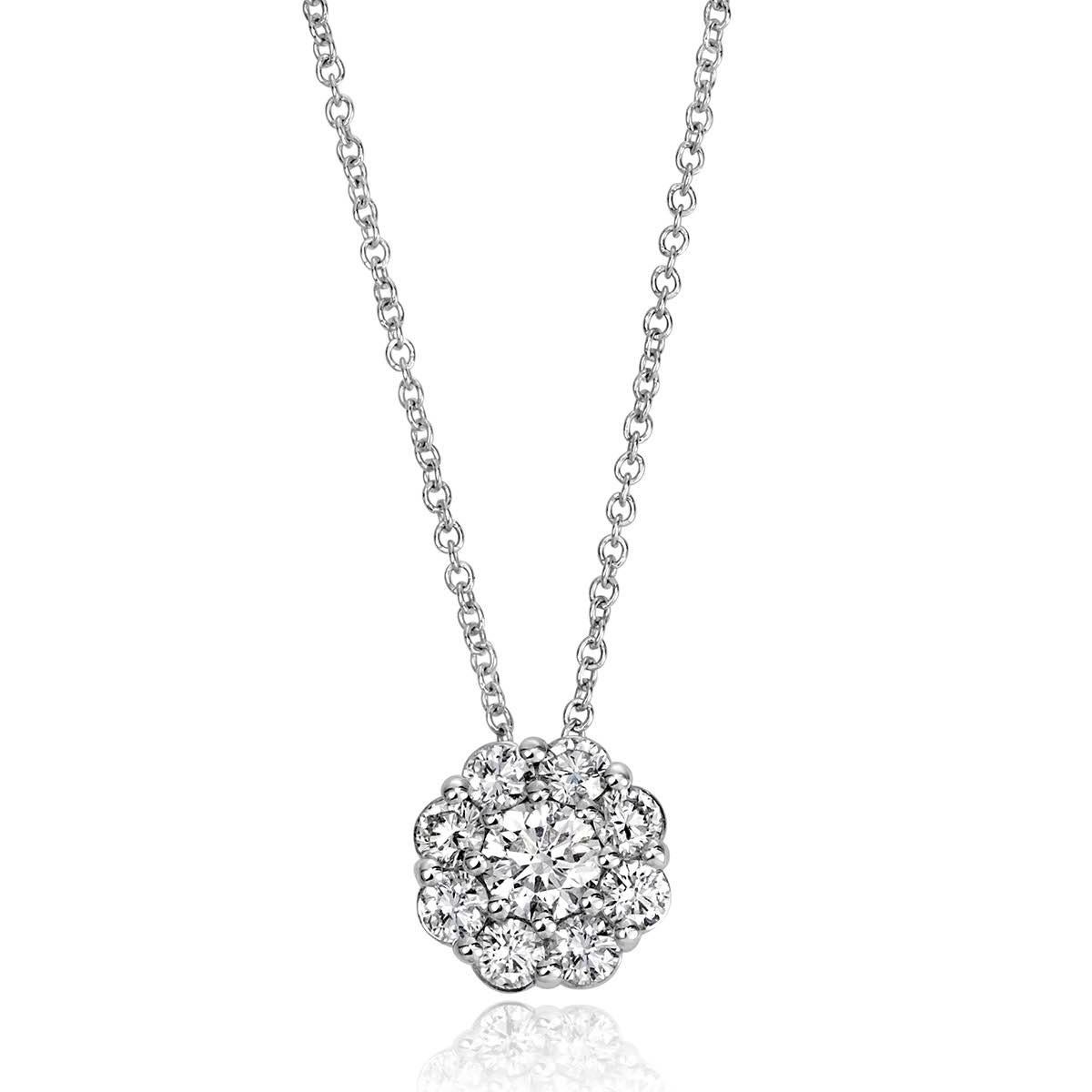 Handcrafted in 14k white gold, this lovely diamond pendant features 0.82ct of round brilliant cut diamonds set in an exquisite floral pattern. The diamonds are graded at E-F in color and VS1-VS2 in clarity. 
