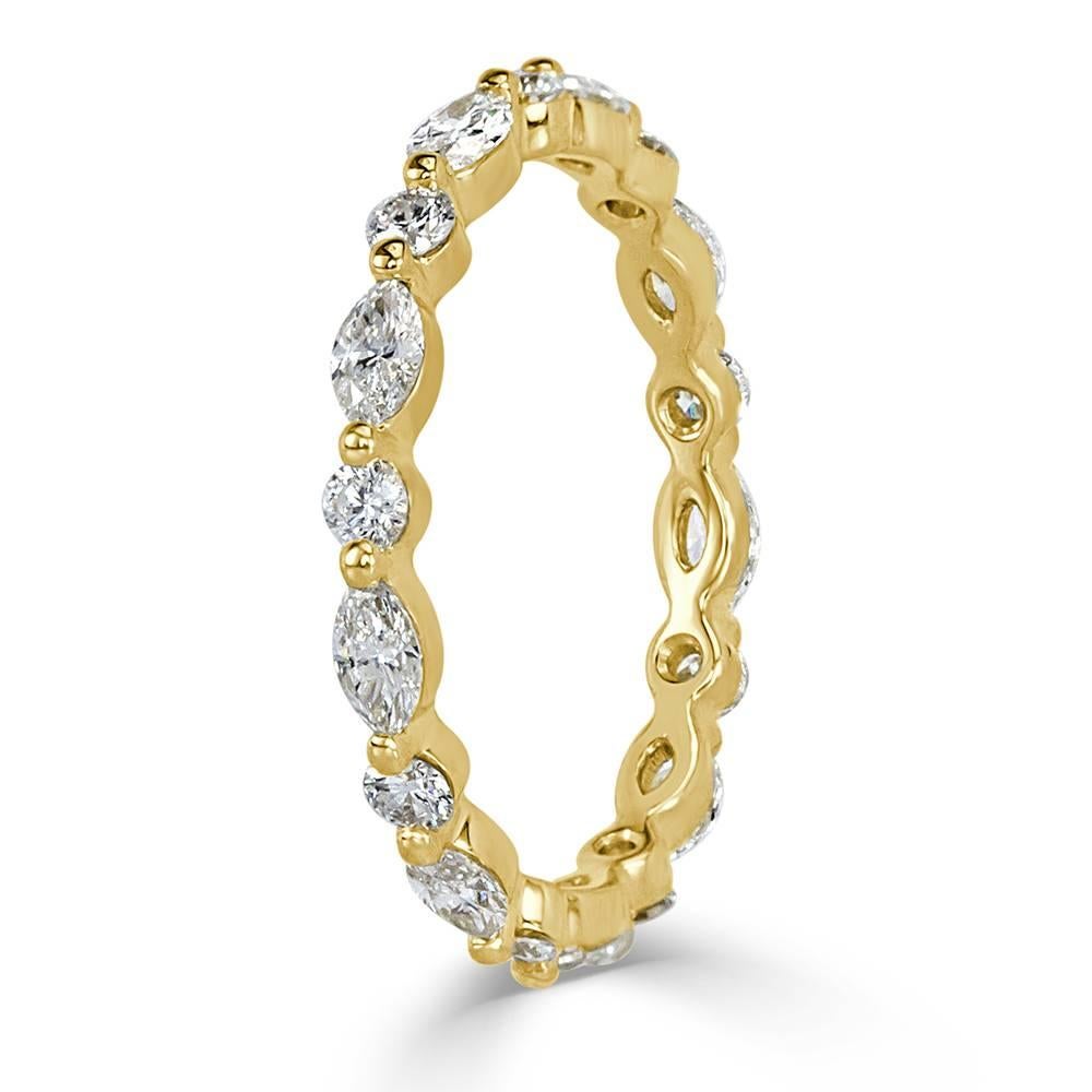 Handcrafted in 18k yellow gold, this exquisite diamond eternity band showcases 1.00ct of marquise and round brilliant cut diamonds graded at E-F, VS1-VS2. They are impeccably matched and set with a single prong for maximum sparkle.