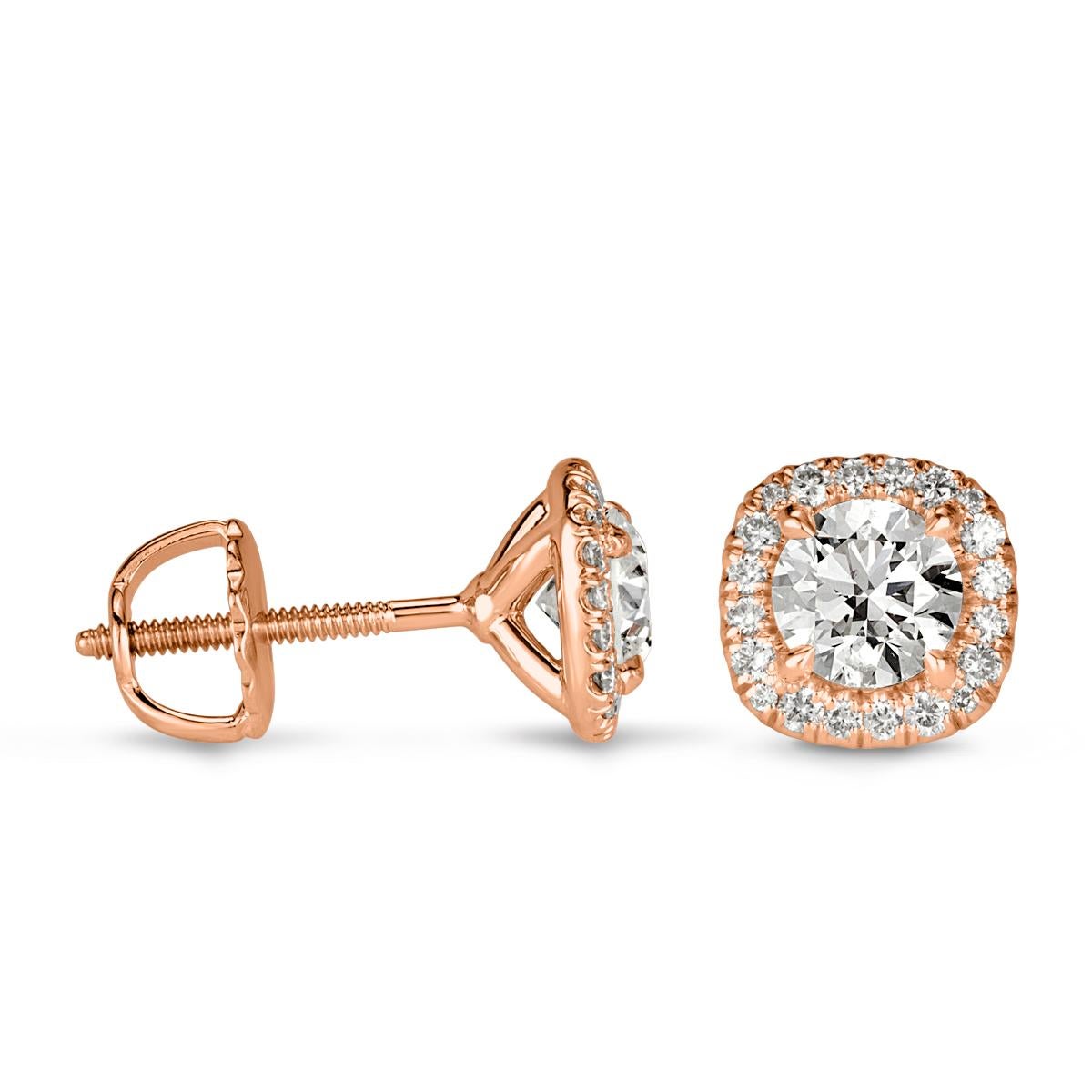 Custom created in 18k rose gold, this ravishing pair of diamond stud earrings showcases two round brilliant cut diamonds each surrounded by a cushion shaped halo of smaller round brilliant cut diamonds. The diamonds total 1.00ct in weight and are