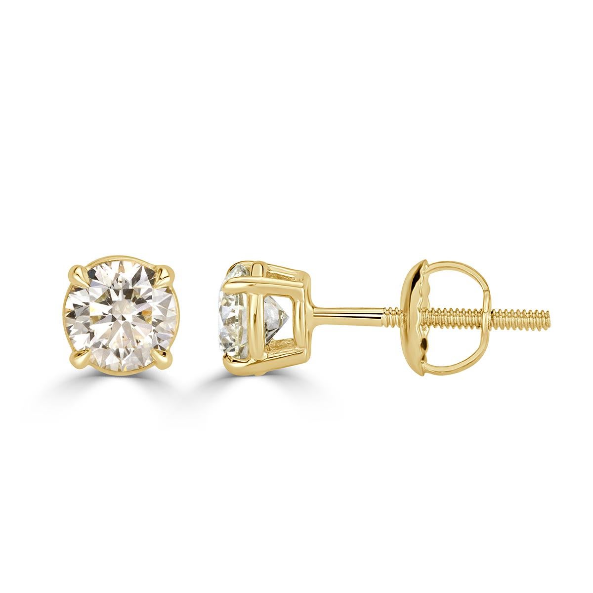 This superb pair of diamond stud earrings features two round brilliant cut diamonds with a total carat weight of 1.00ct. They are graded at G-H in color, SI1-SI2 in clarity and bezel set to perfection in 14k yellow gold. 
