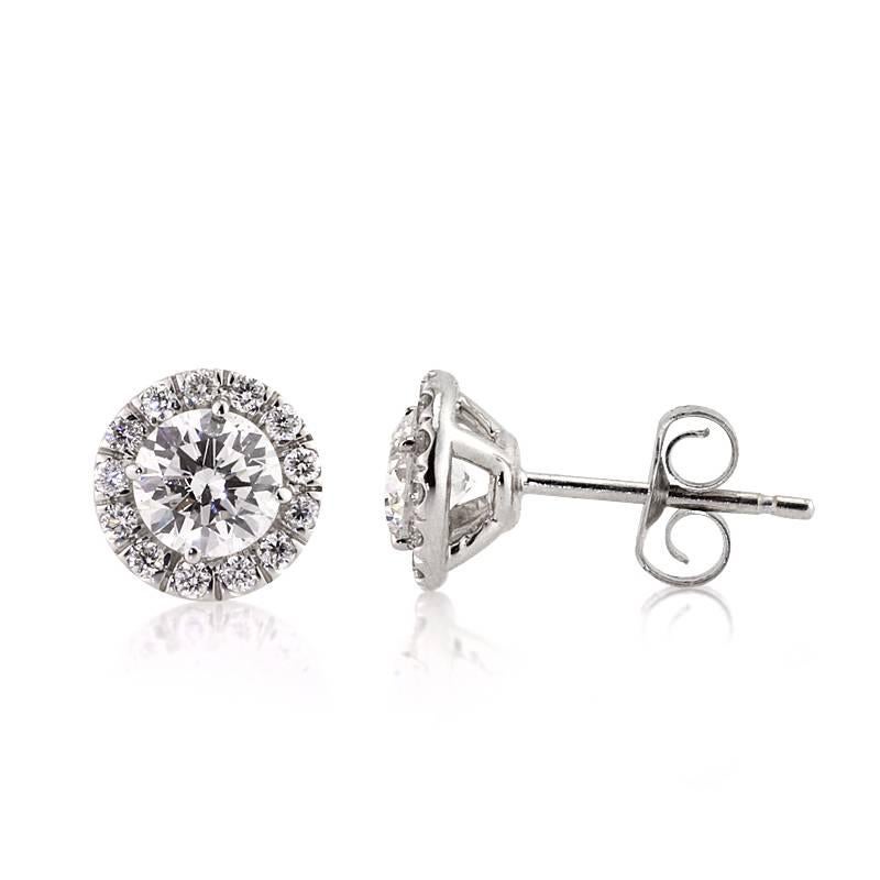 This exquisite pair of diamond stud earrings showcases 1.00ct of round brilliant cut diamonds micro pavé set in 14k white gold. Each of the two sparkling center diamonds is surrounded by a halo of smaller round brilliant cut diamonds. All of the