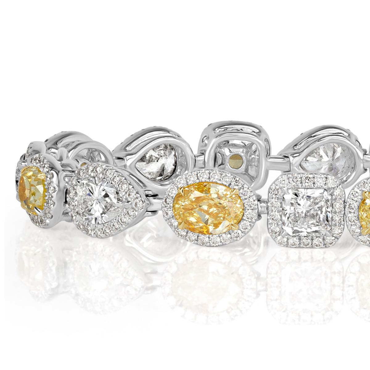 This superb diamond bracelet showcases an exquisite fringe of fancy yellow and white cushion, oval, round and pear shaped diamonds. They are each complimented by a dainty micro pavé halo. The diamonds total 10.00ct in weight and are graded at E-F,