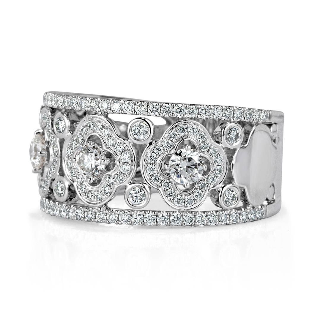 This beautiful right-hand diamond ring is set with 1.00ct of glittering round brilliant cut diamonds graded at E-F in color, VS1-VS2 in clarity. The diamonds are arranged in an exquisite floral design in the center and accented by one row of