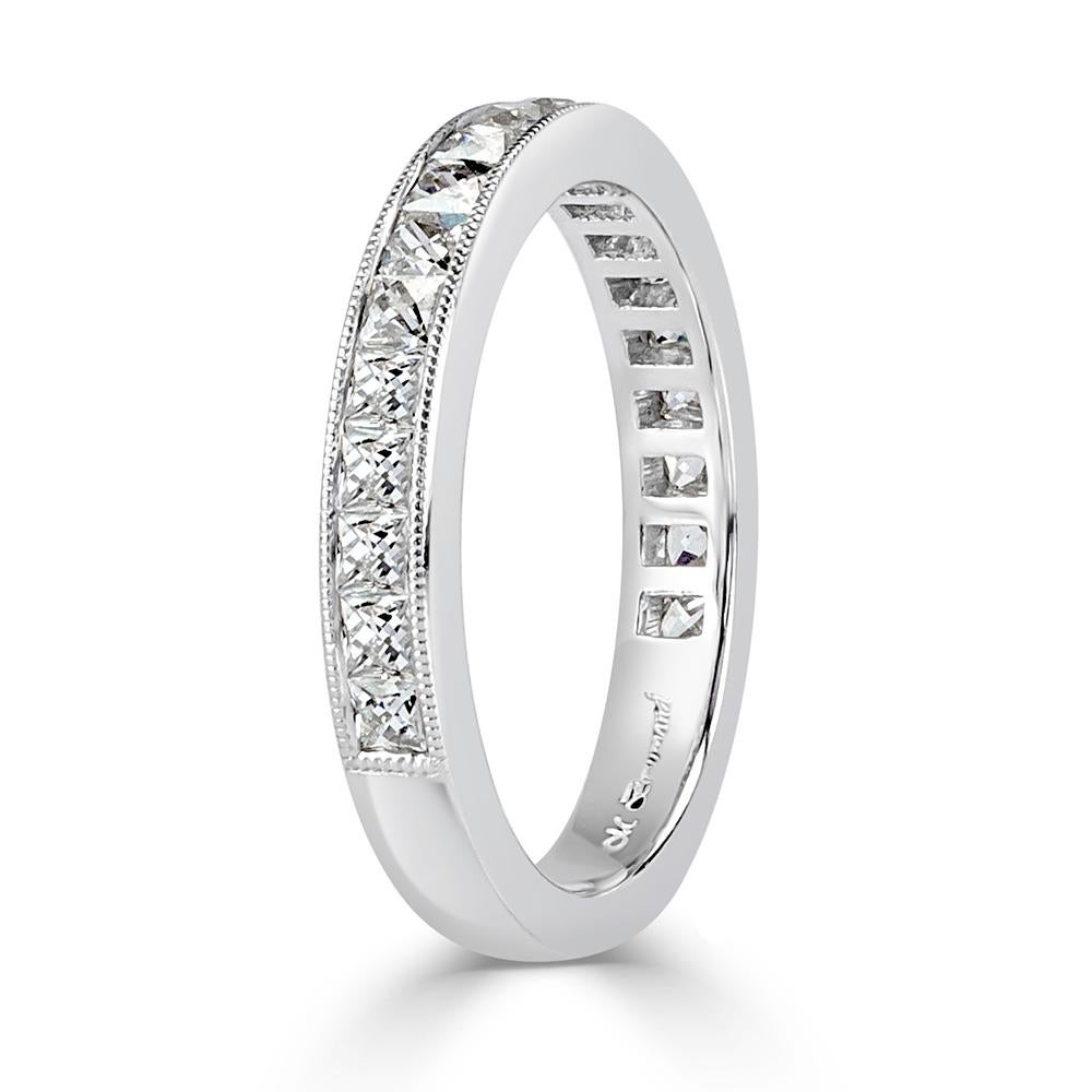 This exquisite, antique style diamond wedding band showcases one row of french cut diamonds channel set in a hand engraved, 18k white gold custom setting. The diamonds total 1.05ct in weight and are graded at E-F, VS1-VS2.
