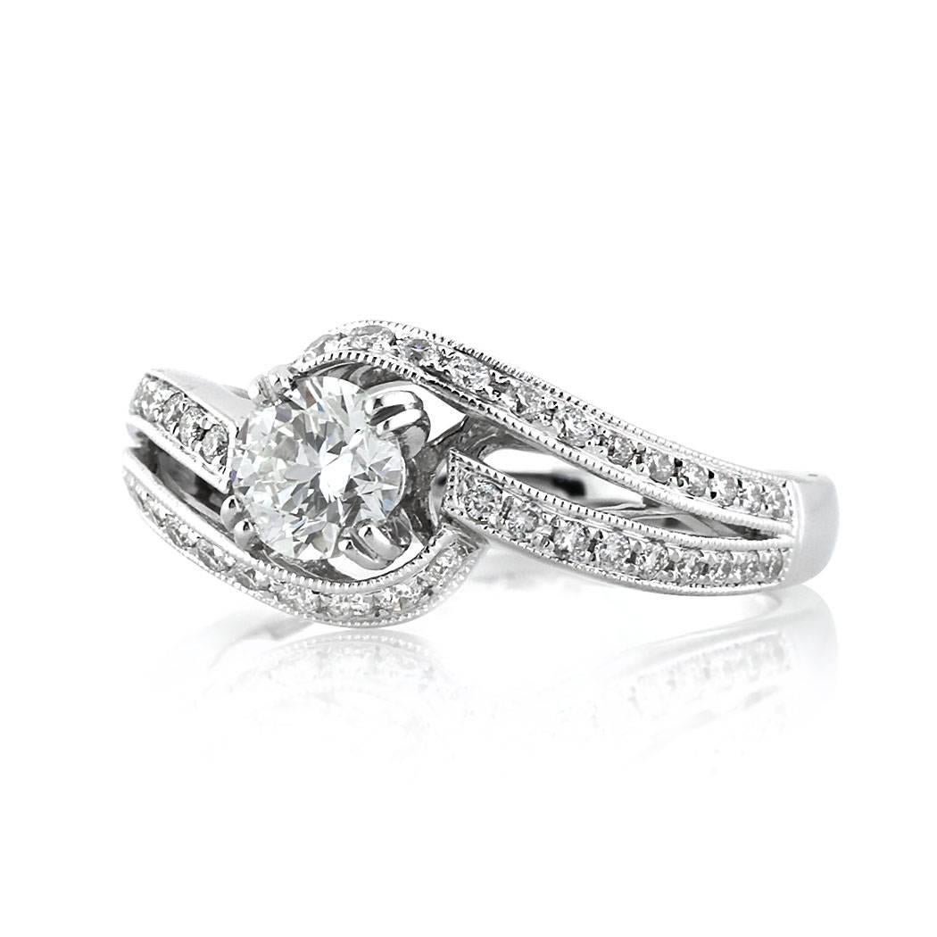This gorgeous diamond engagement ring is superbly handcrafted in 18k white gold and features a beautiful 0.52ct round brilliant cut center diamond, EGL certified at G-VS1. It is accented by 0.55ct of shimmering diamonds pave set on either side of