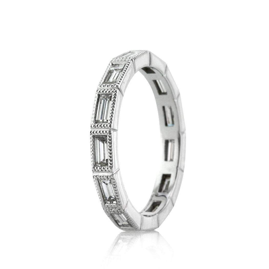 Handcrafted in platinum, this ravishing diamond eternity band showcases 1.10ct of bezel set baguette cut diamonds graded at E-F, VS1-VS2. They are accented by delicate milgrain detail throughout.