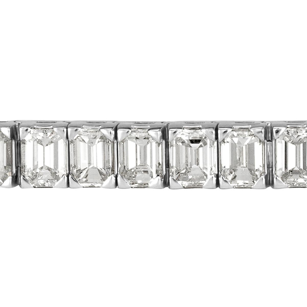Custom designed in a luxurious 18k white gold setting, this stunning diamond tennis bracelet features 11.47ct of seamlessly matched emerald cut diamonds graded at G-H in color, VS1-VS2 in clarity. Each of the diamonds is hand selected and average