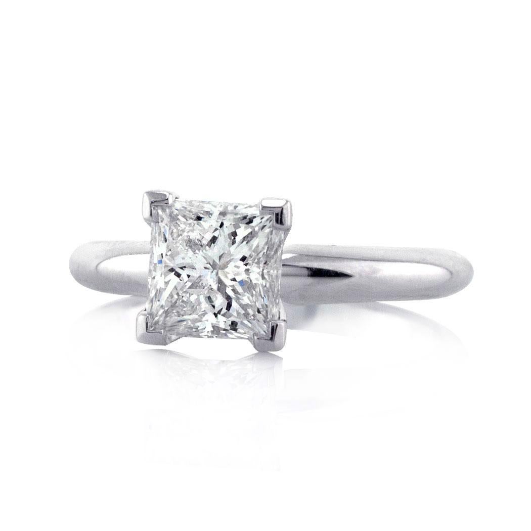 This elegant diamond engagement ring showcases a beautiful 1.21ct princess cut center diamond, EGL certified at G-SI2. It faces up white and eye clean with the inclusions blending in perfectly into the diamond. It is showcased to perfection in a