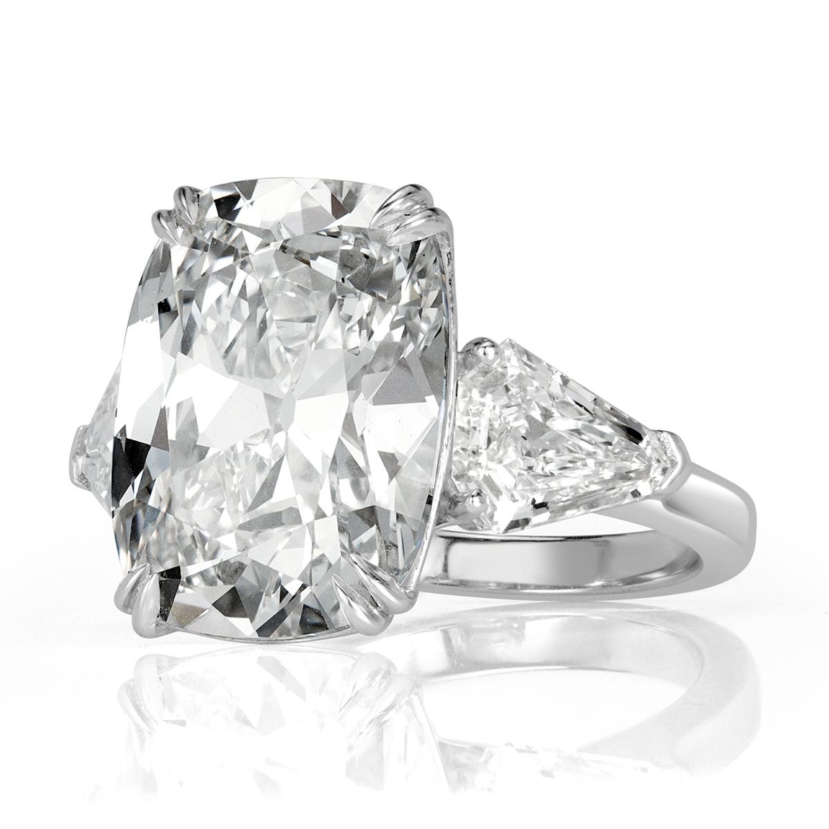 Custom created in platinum, this superb diamond engagement ring showcases a one of a kind 10.31ct old Mine cut center diamond, GIA certified at H-VS1. It has a stunning cut and sparkles with tremendous brilliance. It is complimented by two shield