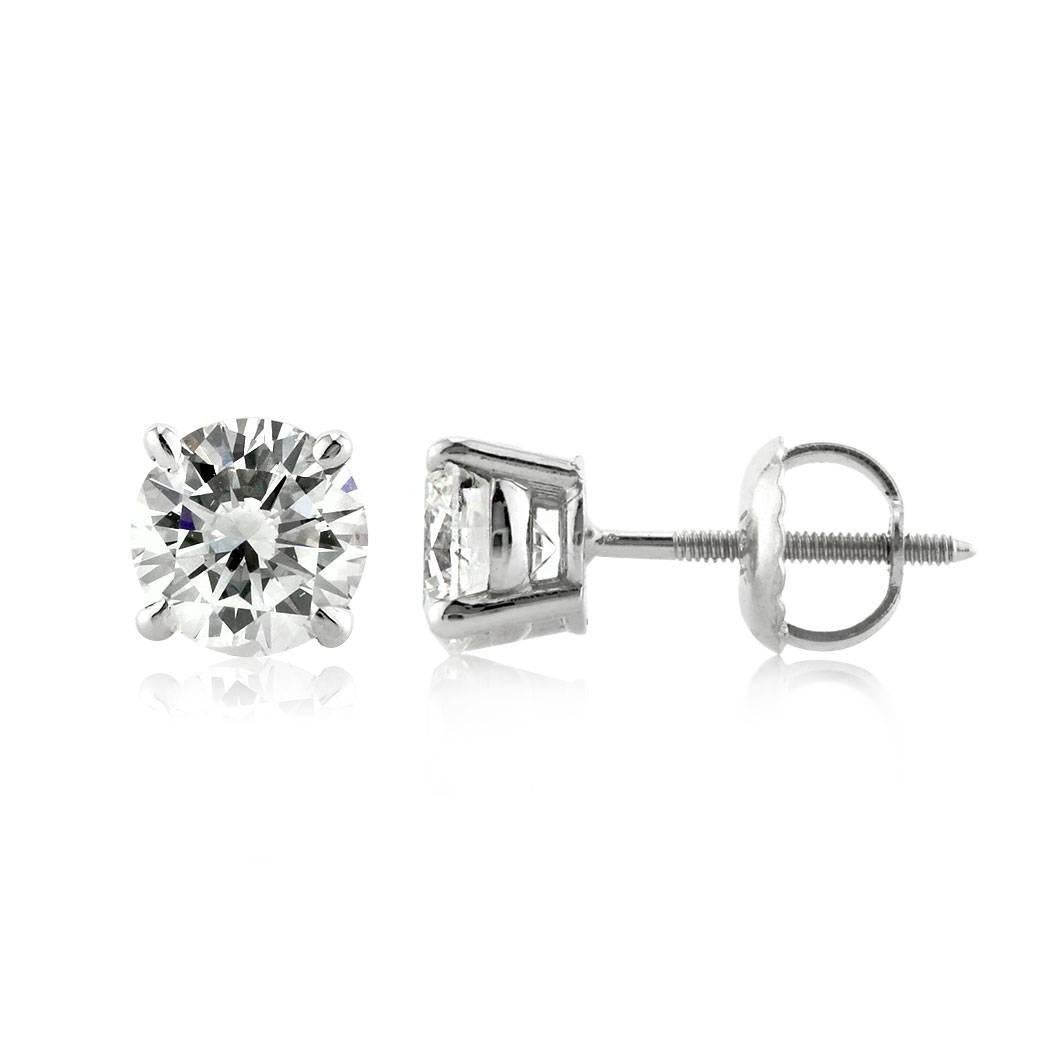 This stunning pair of diamond stud earrings showcases two perfectly matched round brilliant cut diamonds graded at H-VS2 and I-SI1. They are set in a classic 14k white gold setting with screw backs for added security.