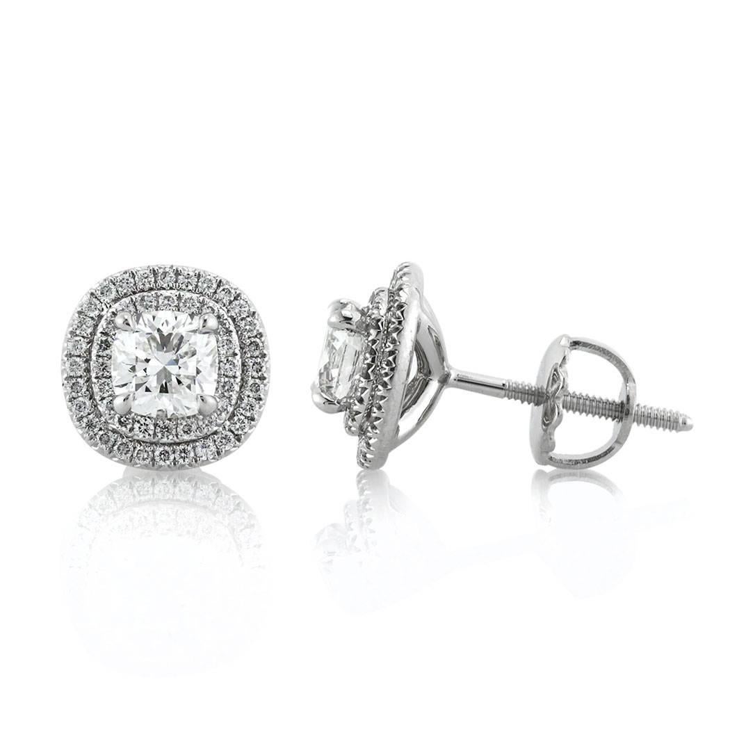 This gorgeous pair of diamond stud earrings features two beautiful cushion cut diamonds with a total weight of 0.83ct. They are each GIA certified at F-VVS1 and F-VVS2 and accented by a double halo of round brilliant cut diamonds. The accent