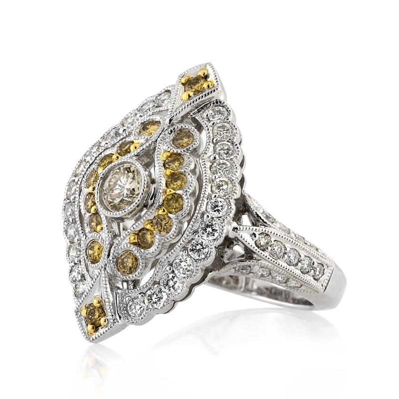 This gorgeous two-tone right-hand ring features 1.25ct of round brilliant cut diamonds. It showcases a vintage design accented by fancy yellow and white diamonds graded at VS2-SI1 in clarity. The elongated design enables full coverage of the finger