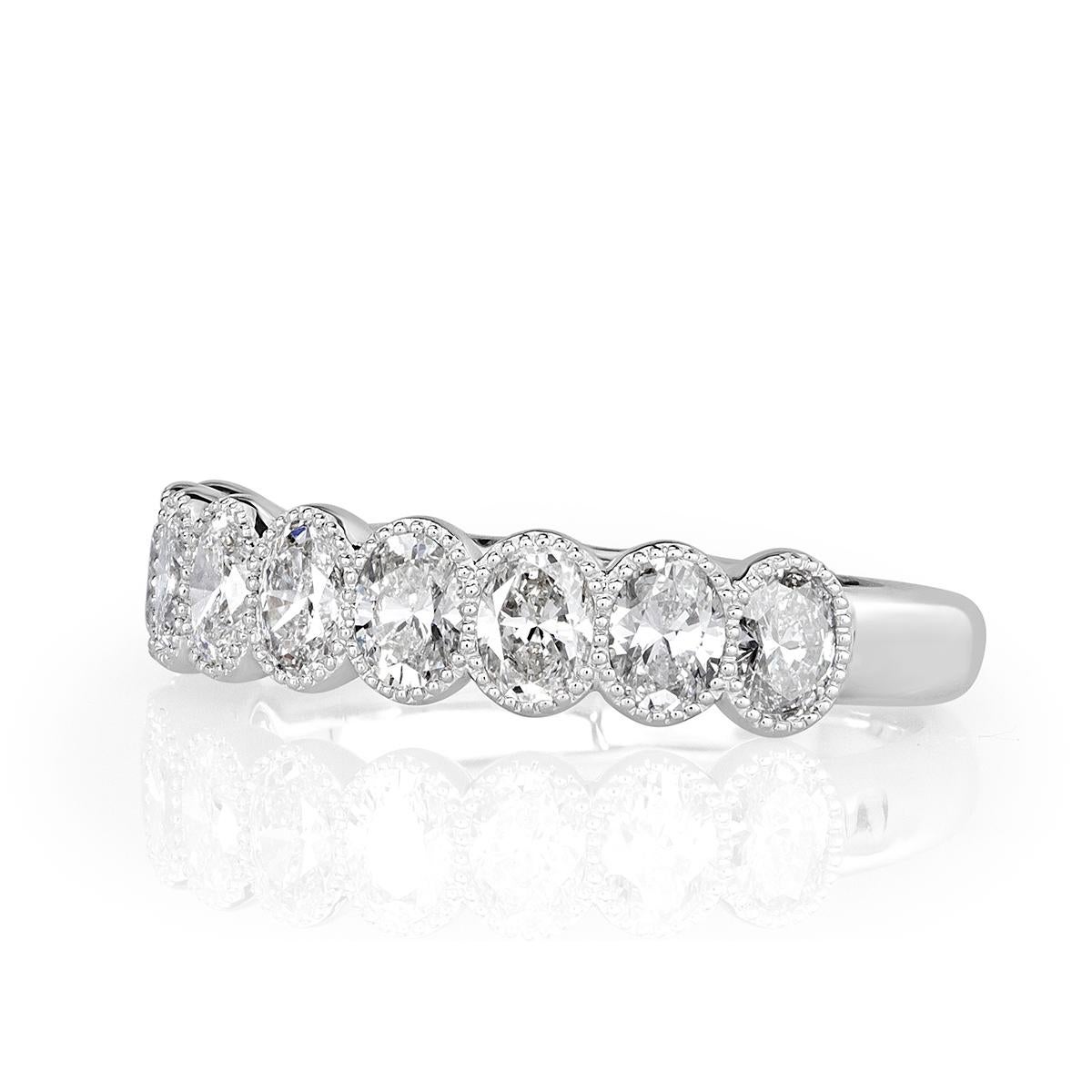 Custom created in 18k white gold, this delightful diamond band showcases 1.26ct of oval cut diamonds each accented by delicate hand milgrain detail. The diamonds are graded at E-F in color, VVS2-VS1 in clarity.