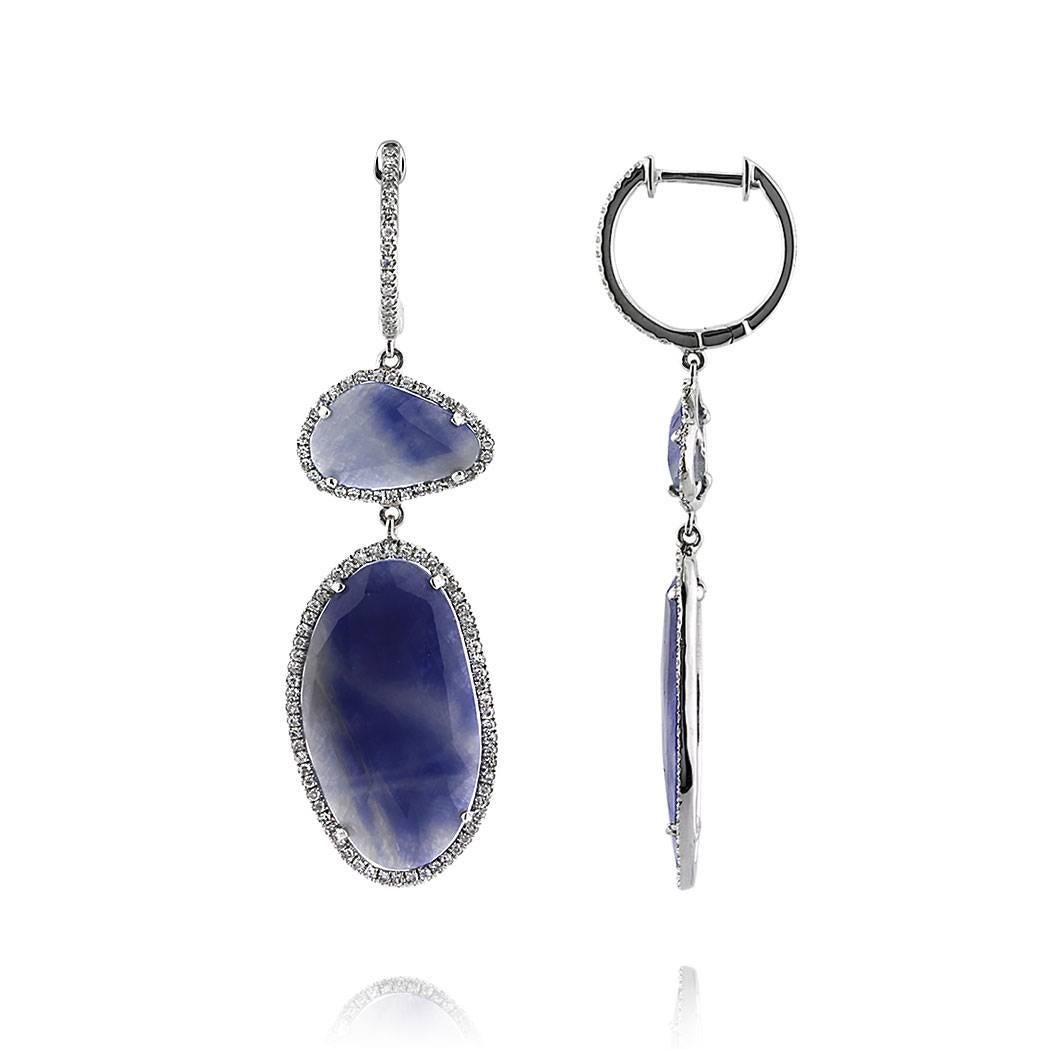These beautiful pair of dangle earrings features 12.34ct of sapphire slices set in high polish 14k white gold and each accented by peerless white single cut round diamonds. The diamonds total 0.55ct in weight and are graded at G-H, SI1-SI2.
