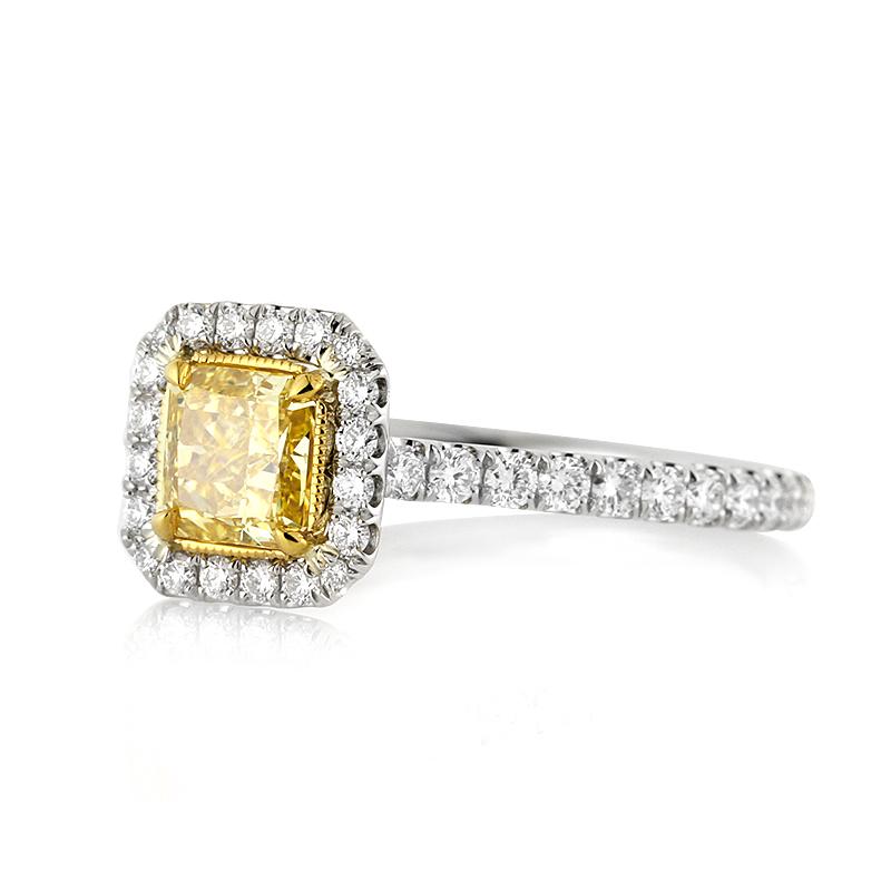 This exquisite diamond engagement ring features a 0.70ct radiant cut center diamond, GIA certified at fancy intense yellow-SI2. It is beautifully showcased in a yellow gold center basket and complimented by a dazzling halo of white, round brilliant